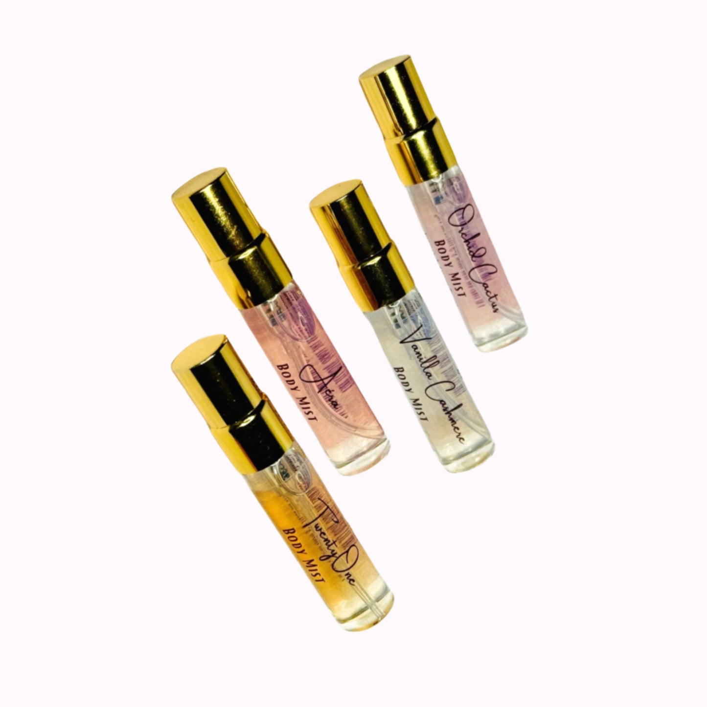 Four small perfume bottles with gold caps on a white background