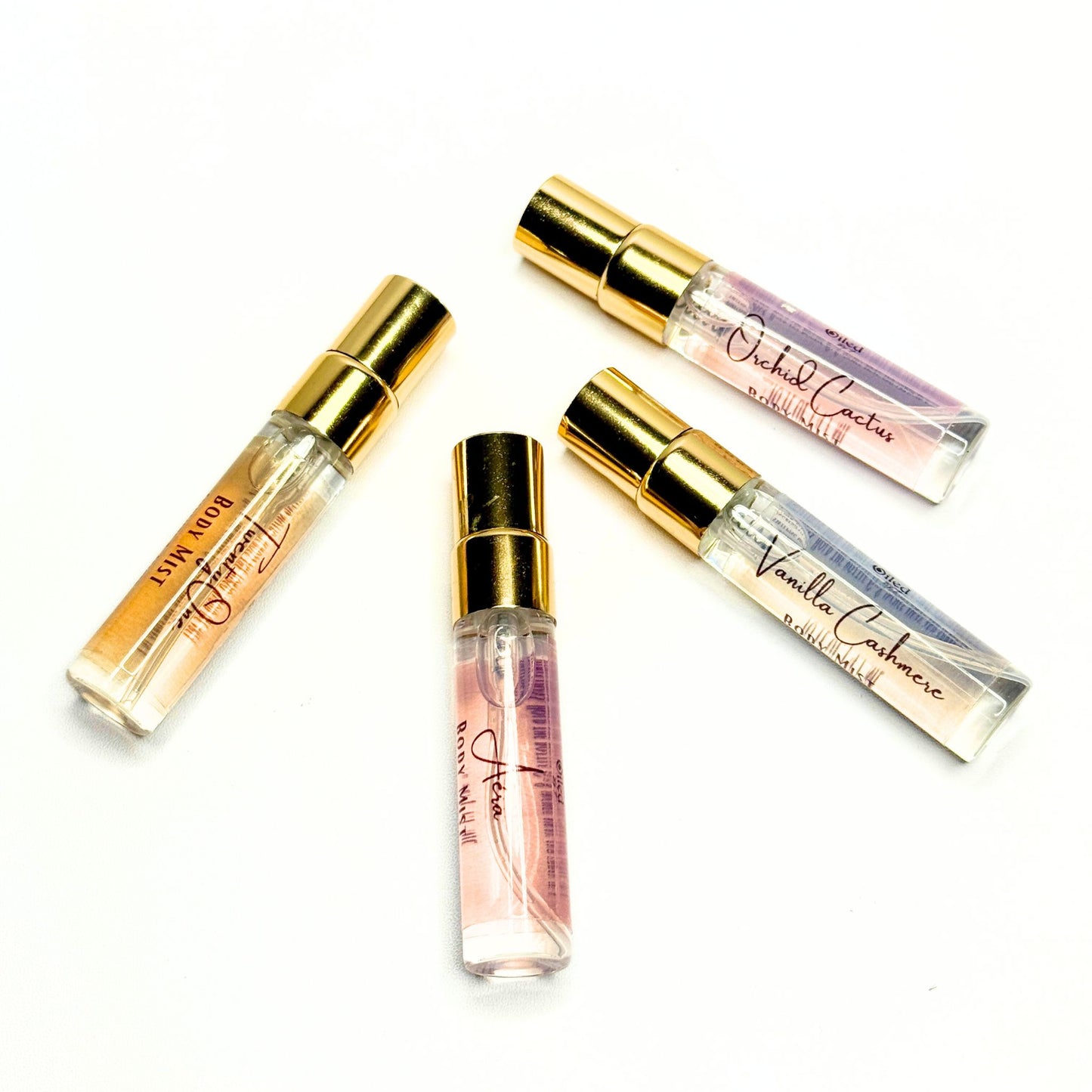 Set of small perfume bottles with gold caps on a white background