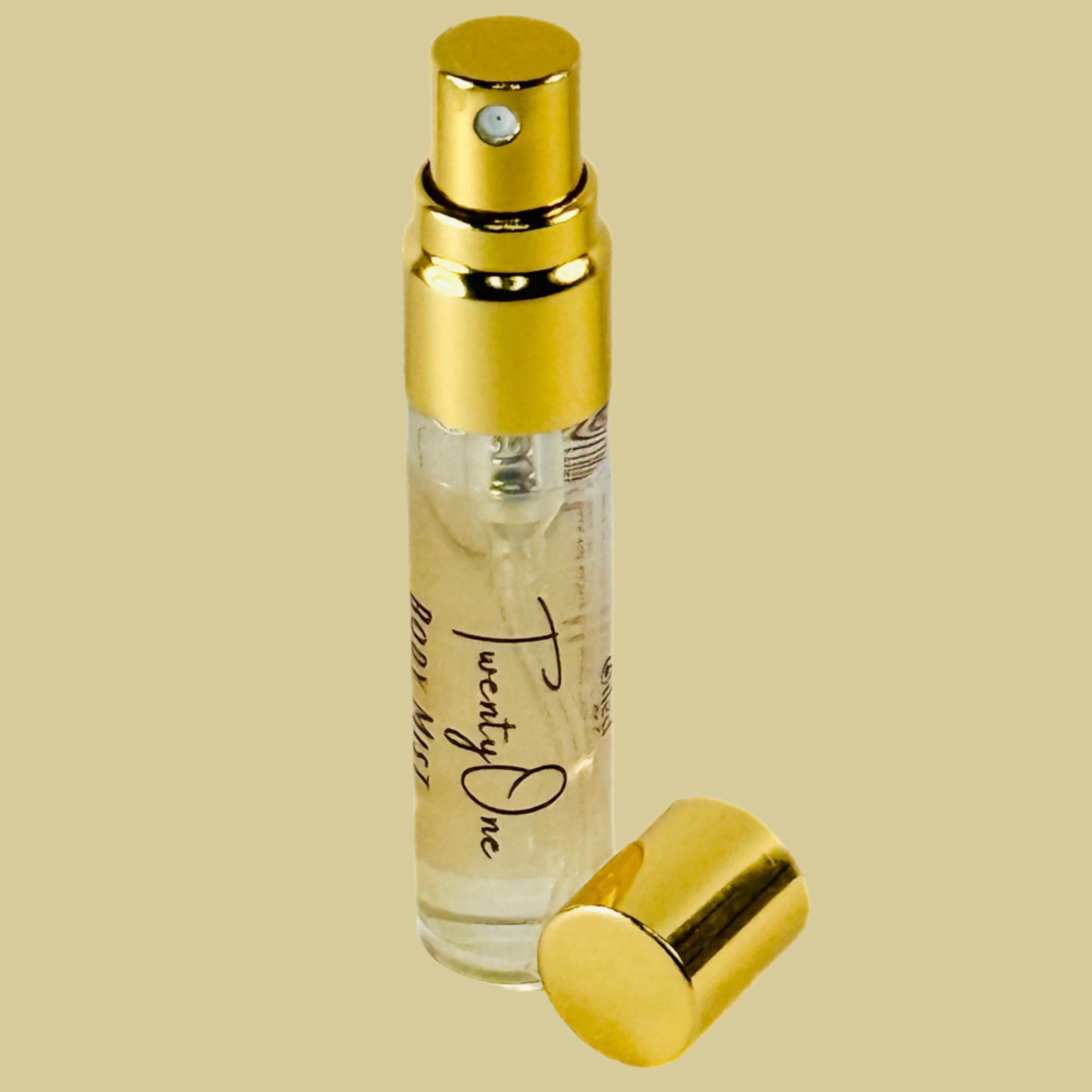 Small perfume bottle with gold cap and clear body on a white background