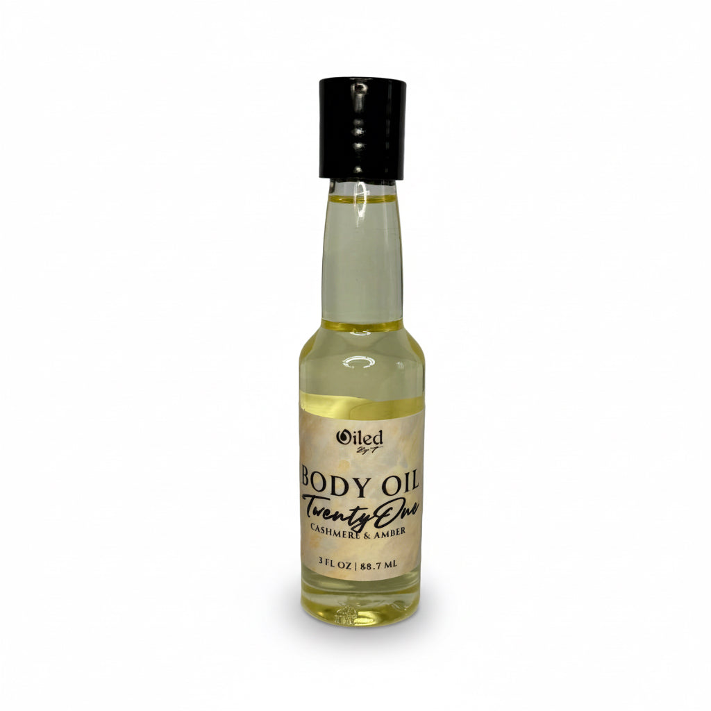 3oz Bottle of body oil with a black cap on a white background