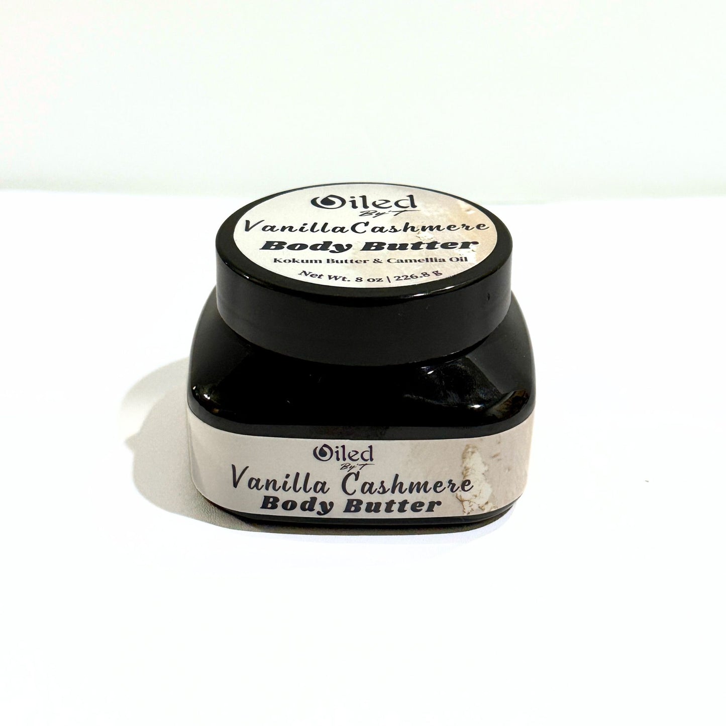 A jar of Oiled by't Vanilla Cashmere Body Butter on a white background.