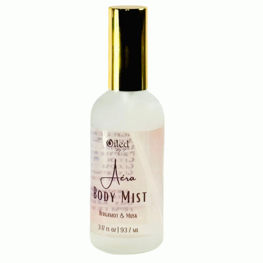 Body mist bottle with gold cap on a white background