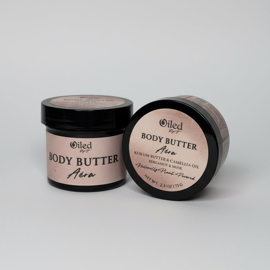 Two jars of body butter labeled 'Oiled' on a light gray background