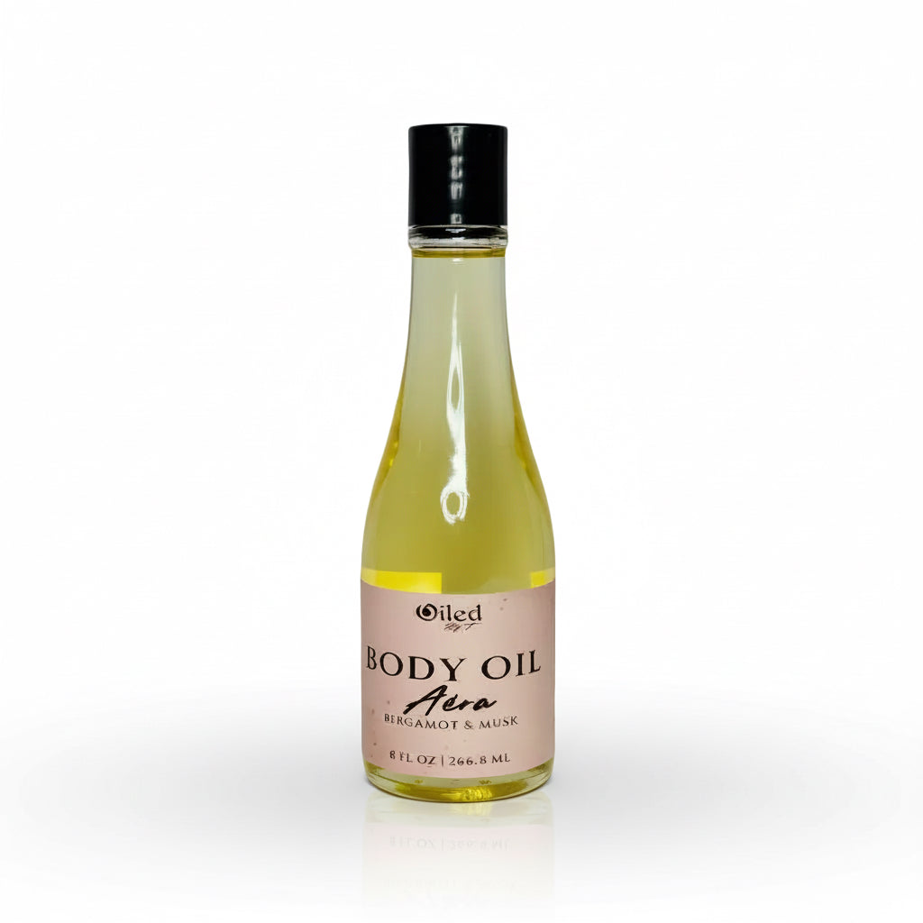8oz Bottle of body oil scented with bergamot and musk with a black cap on a white background