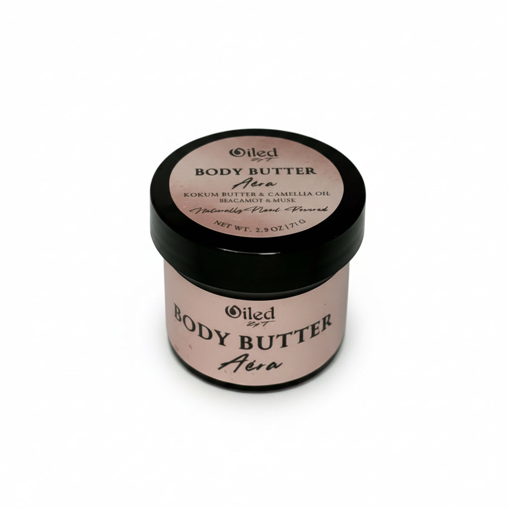 2.5 oz Jar of body butter with pink label and black lid on a white background