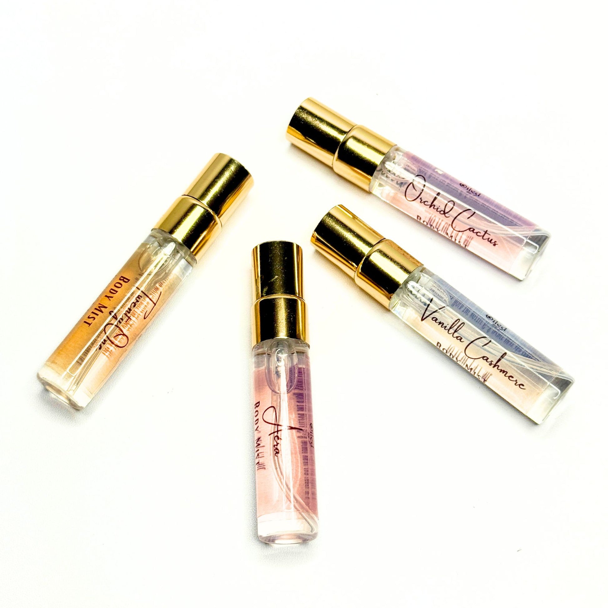 Set of small perfume bottles with gold caps on a white background