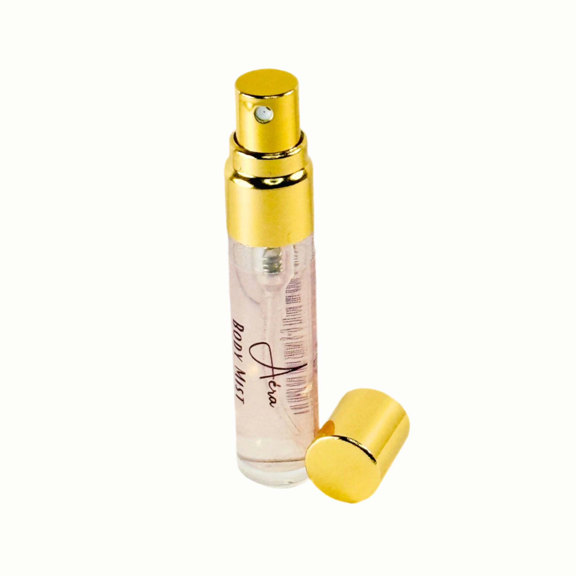 Perfume bottle with gold cap and clear body mist on a white background