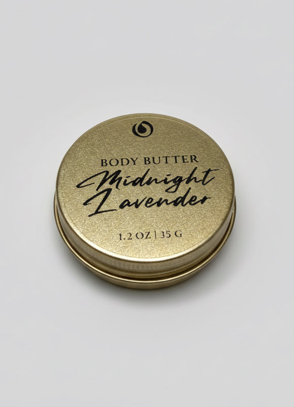 Gold container of 'Midnight Lavender' body butter with 'Midnight Lavender' text on a light gray background