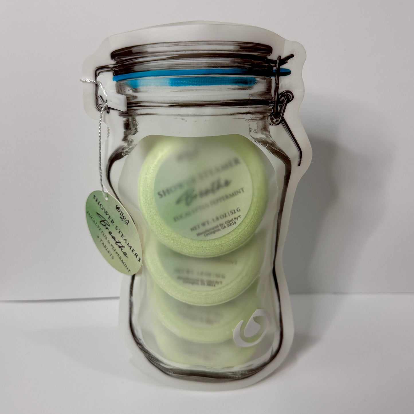 Plastic stand up  pouch mason jar shape with four Breathe Shower Steamers inside on a white background