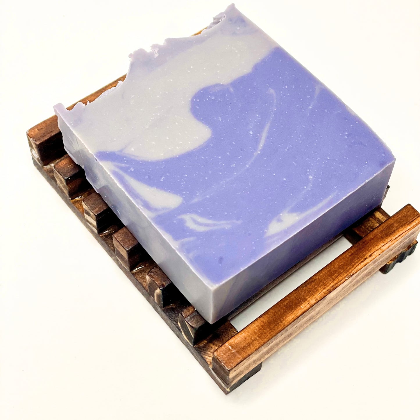 Artisan soap bar made with Kokum butter bluish purple color displayed on wooden soap dish