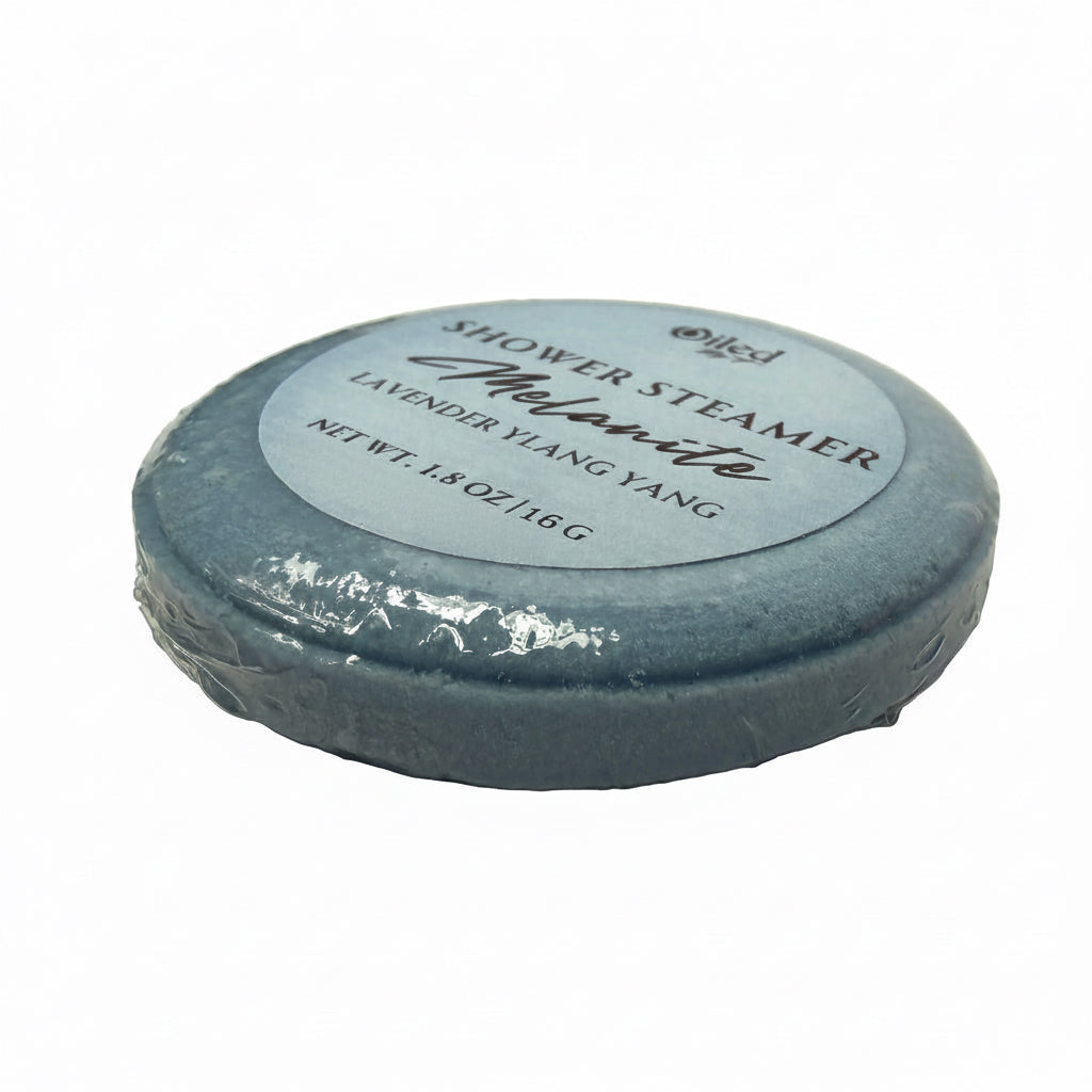 Blue shower steamer with a label on a white surface