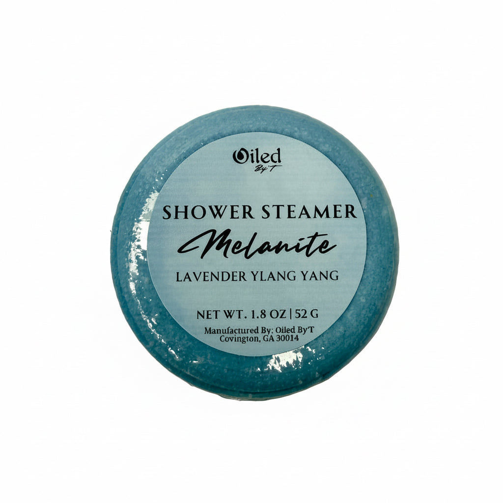 Blue shower steamer with Lavender and Ylang Ylang essential oils labeled 'Oiled by T' on a white background
