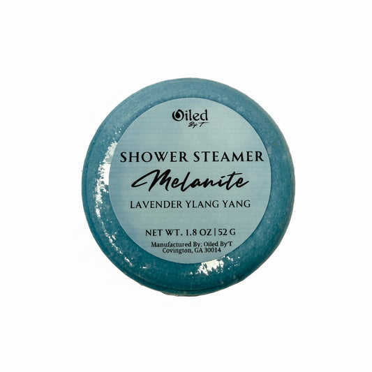 Blue shower steamer with Lavender and Ylang Ylang essential oils labeled 'Oiled by T' on a white background