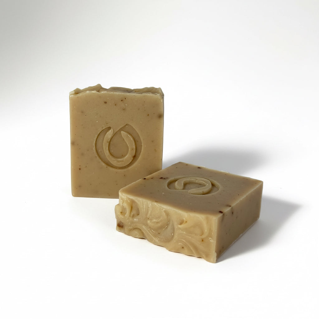 Two beige soap bars with a logo on a white background
