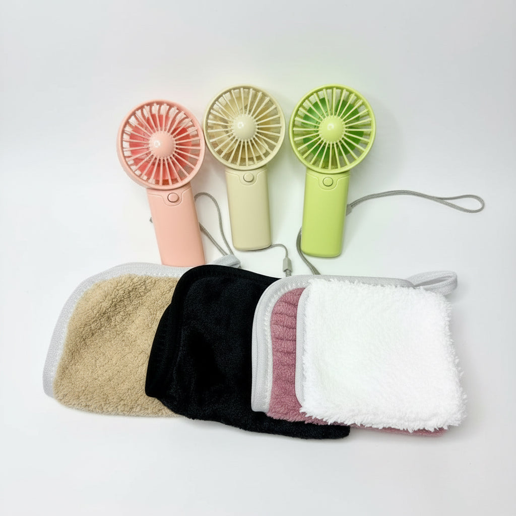 Three handheld fans in pink, beige, and green with three washcloths in beige, black, and pink on a white background.