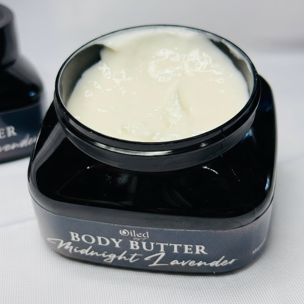 Opened Black jar of 'Midnight Lavender' body butter on a white background
