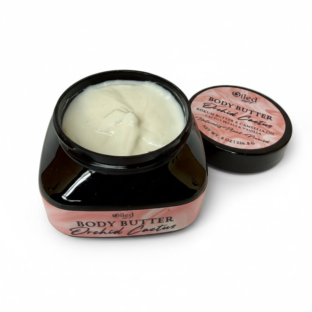 Jar of body butter with a pink label on a white surface