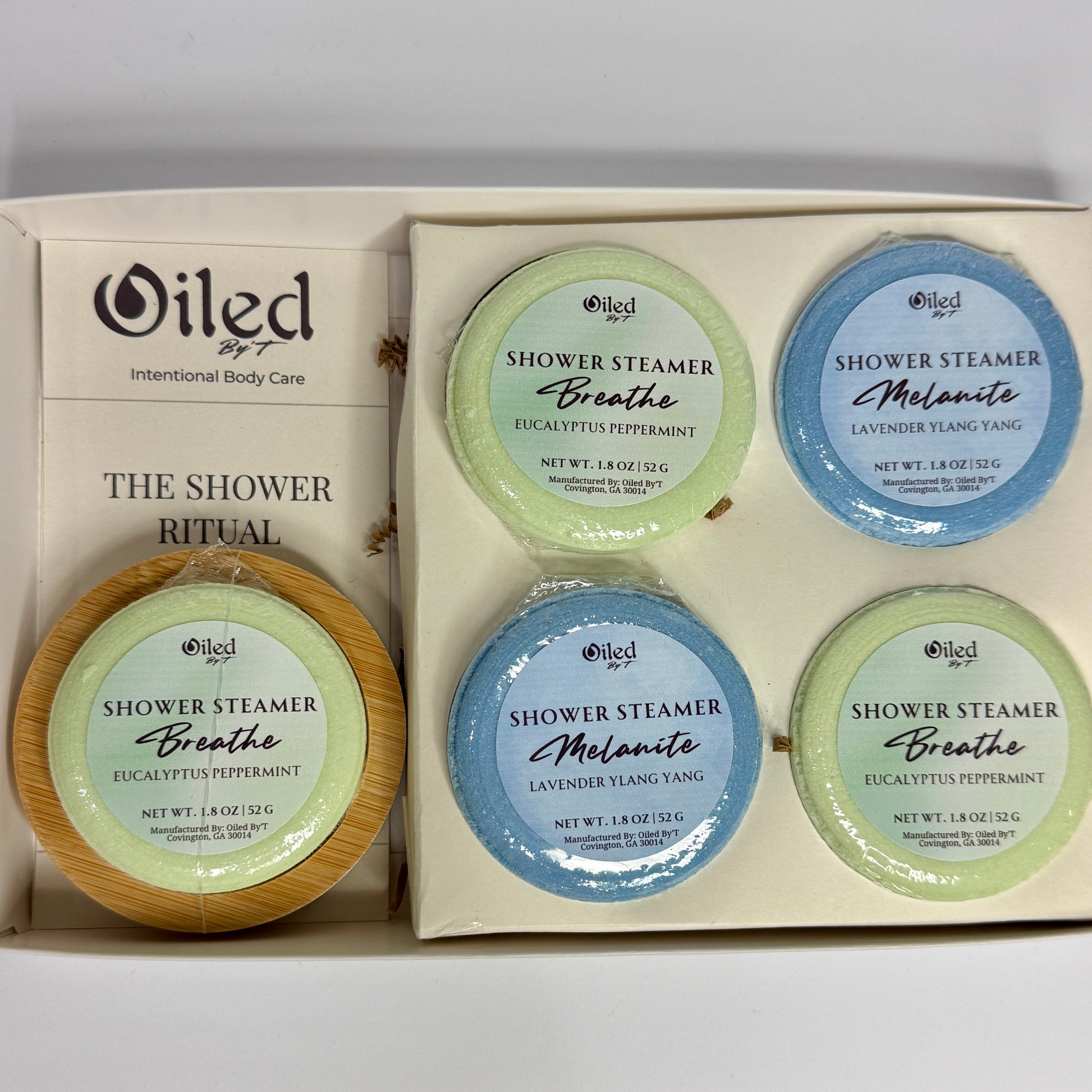 Oiled by 7 shower steamer set with 'Breathe' and 'Melanitee' scents in a box.