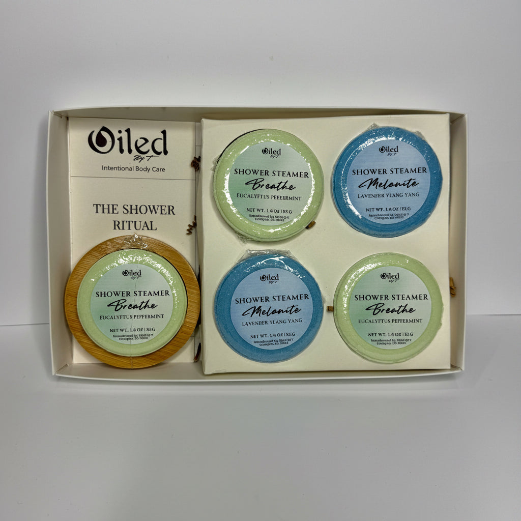 Set of 5 shower steamers in a box with 'Oiled By'T' branding on a white background