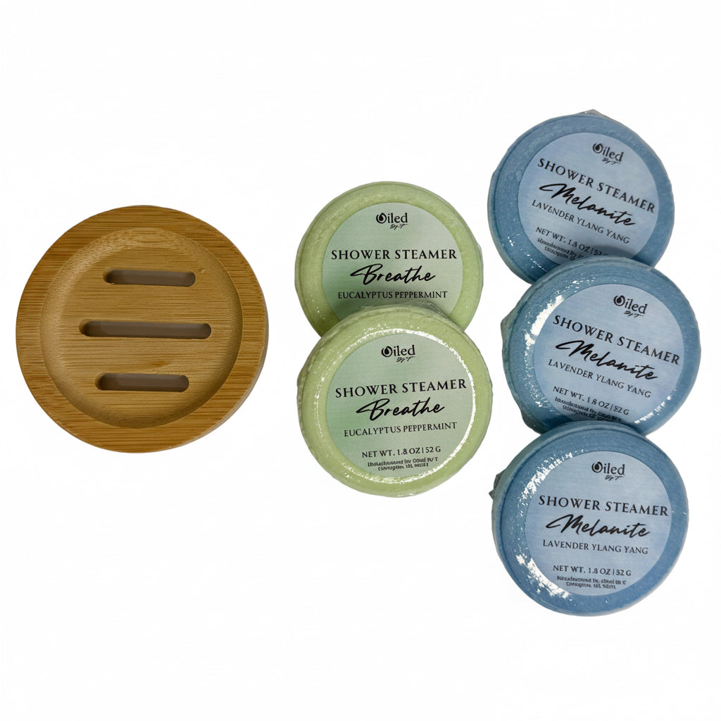 Set of shower steamers with a bamboo soap dish on a white background