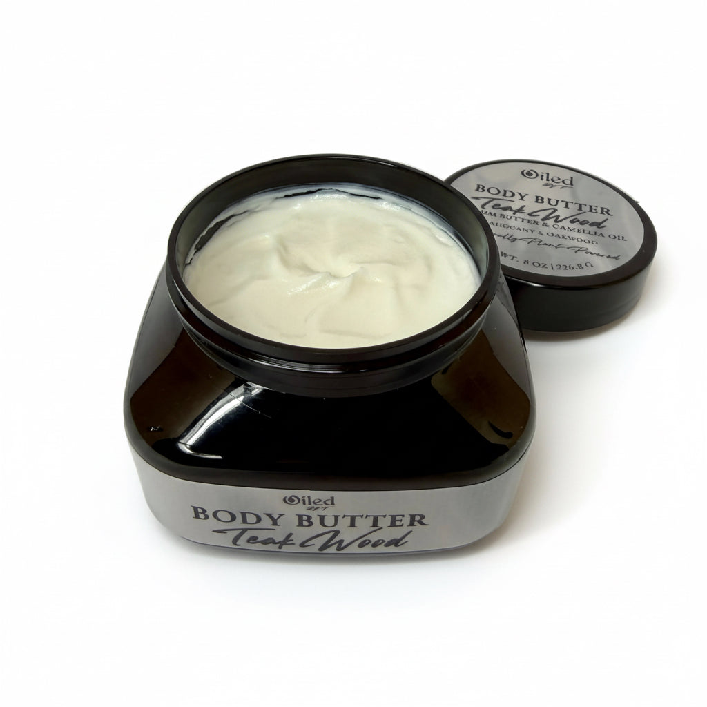 Black jar of body butter labeled 'Teak Wood' on a white background