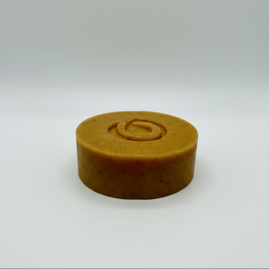 Orange soap bar with a circular design on a white background