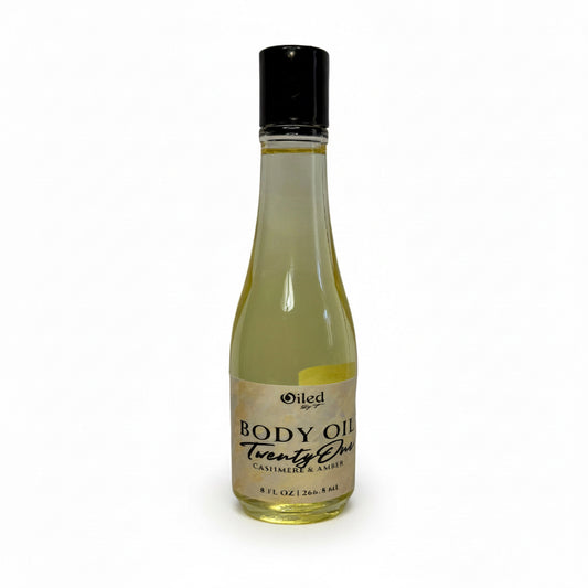 8 oz Bottle of body oil with a black cap on a white background