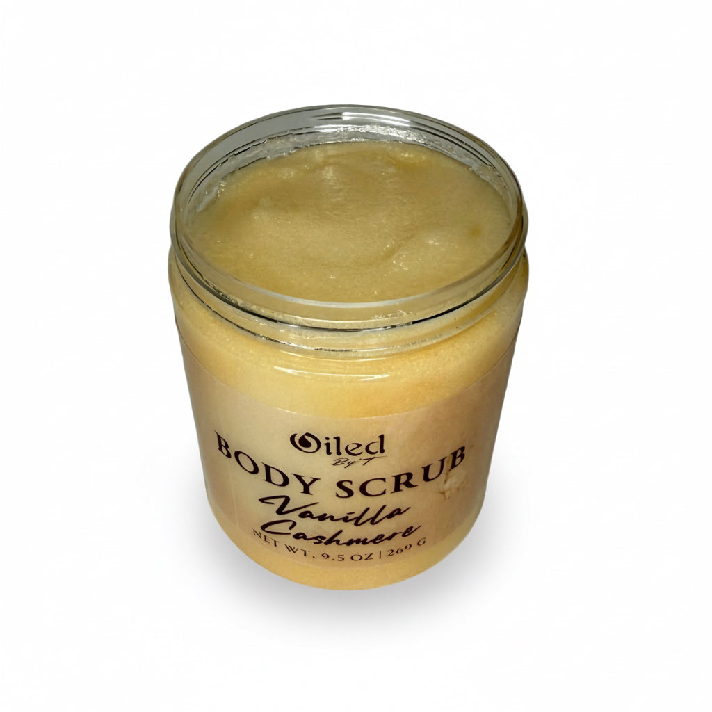 Jar of body scrub scented with vanilla on a white background opened to display contents inside jar. 